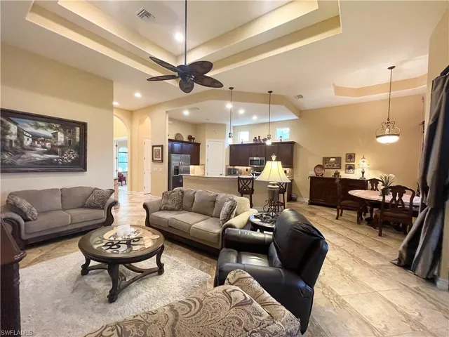 a living room with furniture and a chandelier