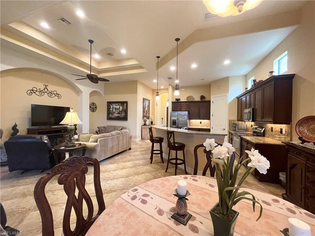 7302 Acorn Way Naples, FL 34119 - Photo 10 of 40 a living room with lots of furniture and a flat screen tv