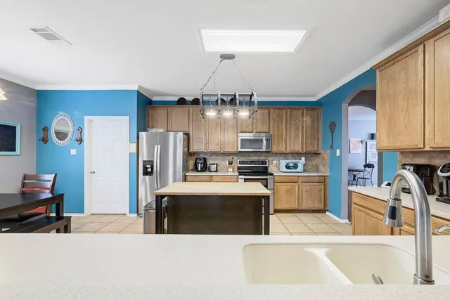 a large kitchen with a lot of counter space and stainless steel appliances