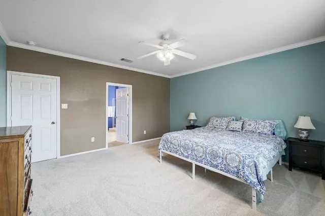 a bedroom with a bed and a ceiling fan