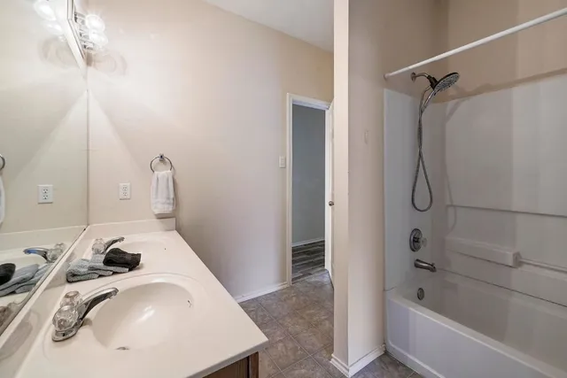 a bathroom with a sink and shower