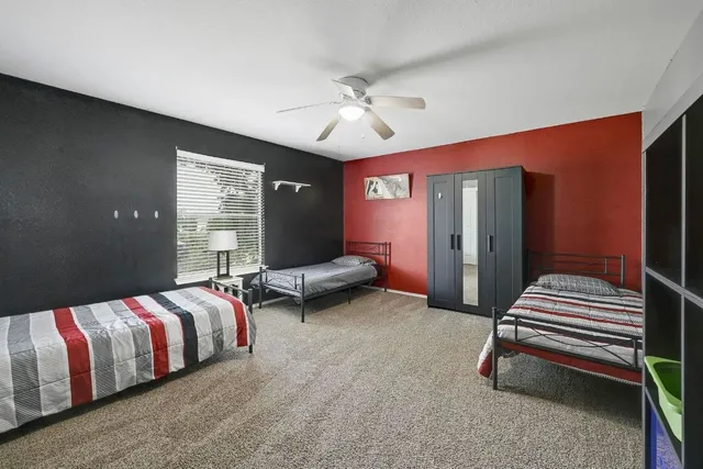 a bedroom with bed and window