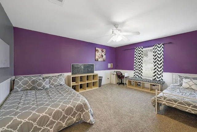 a bedroom with a bed and a chair