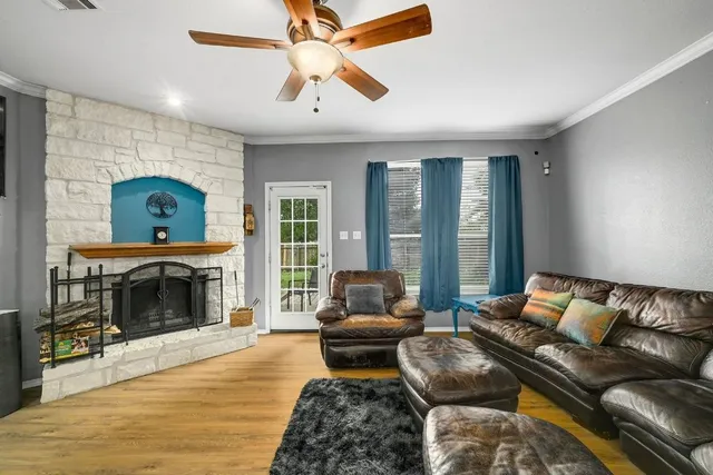 a living room with furniture a fireplace and a flat screen tv