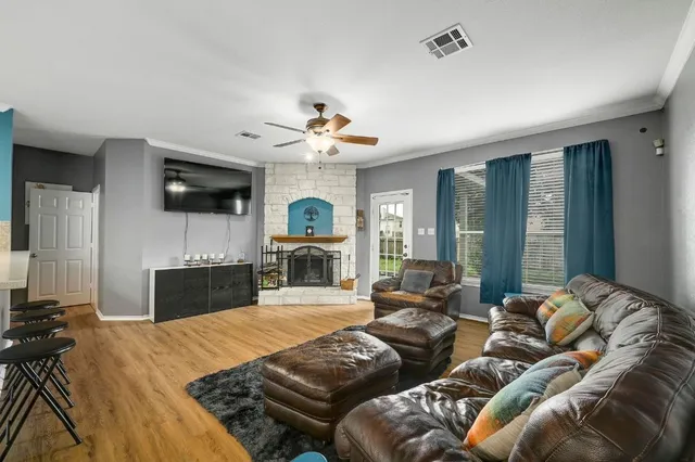 a living room with furniture a fireplace and a flat screen tv
