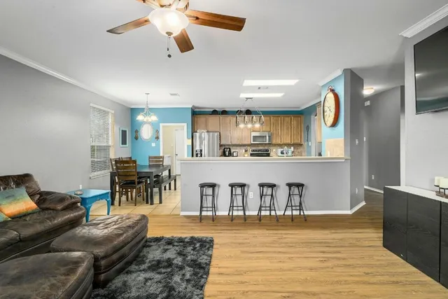 a living room with furniture and a wooden floor