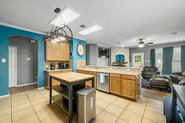 a kitchen with cabinets and chairs