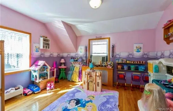 a bed room with furniture and a baby crib