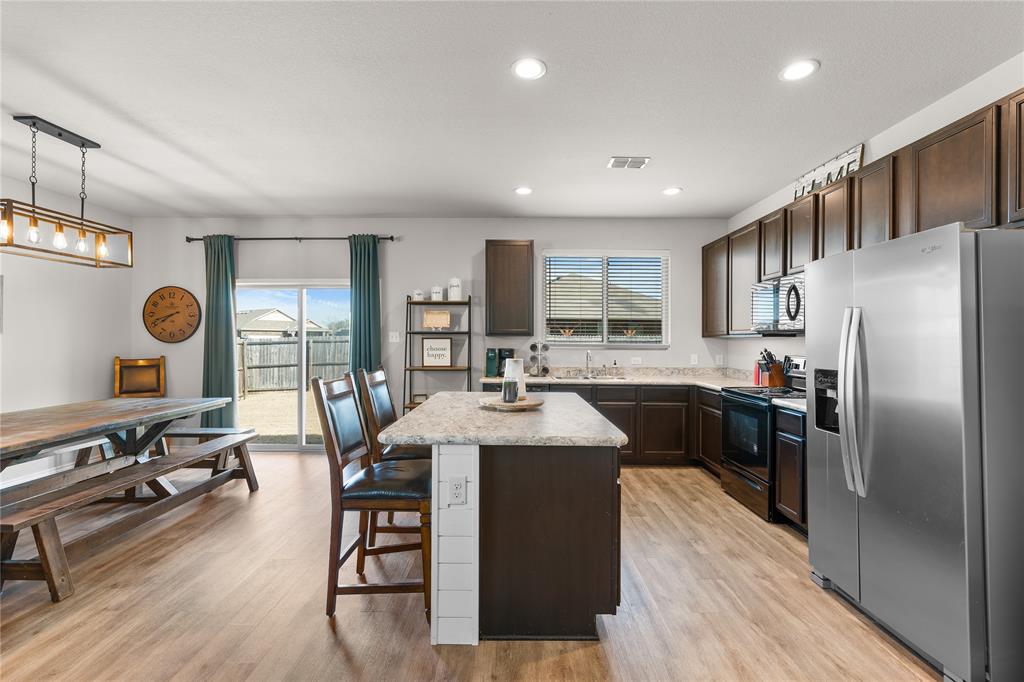 1061 Stanridge Lane Van Alstyne, TX 75495 - Photo 16 of 37 a kitchen with counter top space a sink appliances and cabinets