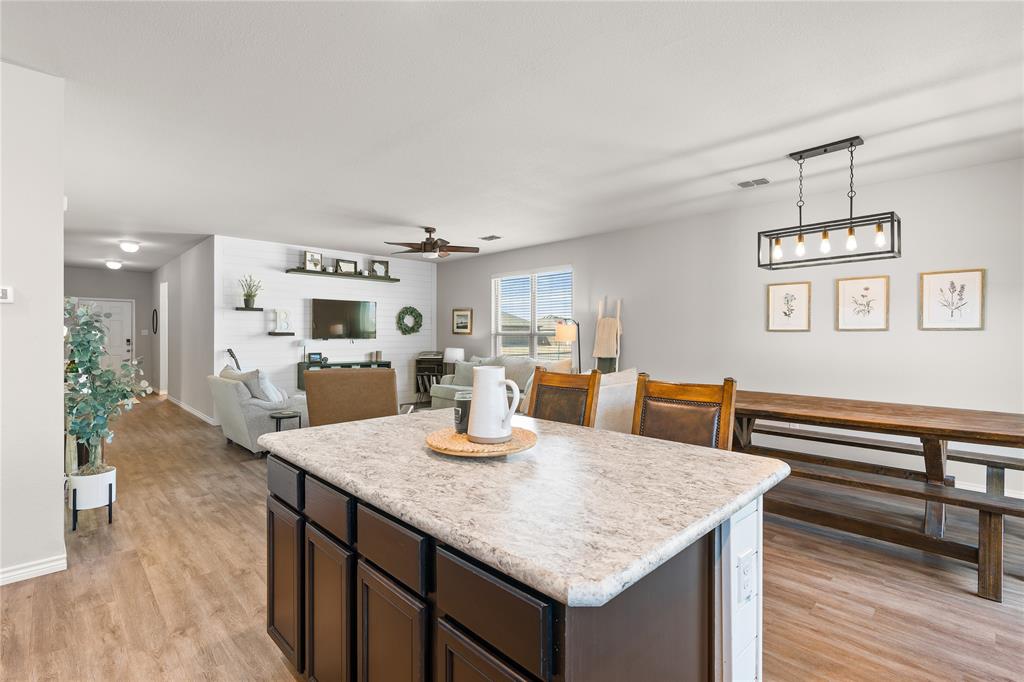 1061 Stanridge Lane Van Alstyne, TX 75495 - Photo 19 of 37 a kitchen with stainless steel appliances granite countertop a kitchen island a stove and a sink