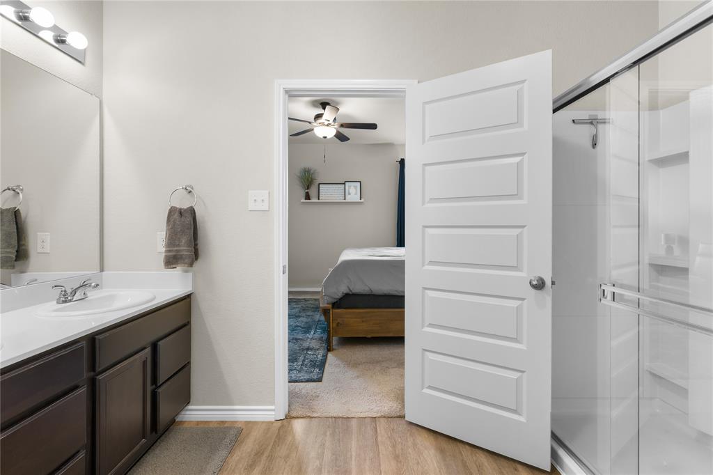 1061 Stanridge Lane Van Alstyne, TX 75495 - Photo 26 of 37 a bedroom with a bed and a mirror