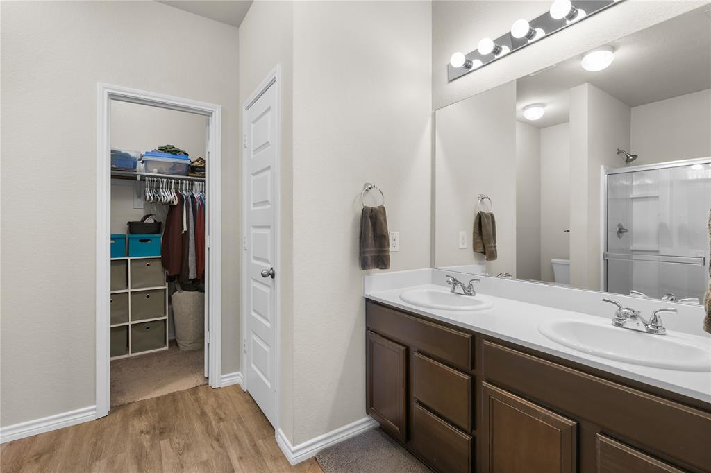 1061 Stanridge Lane Van Alstyne, TX 75495 - Photo 27 of 37 a bathroom with a sink a vanity and a mirror