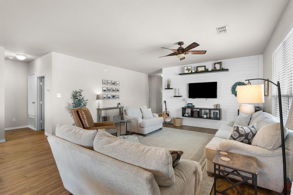 1061 Stanridge Lane Van Alstyne, TX 75495 - Photo 28 of 37 a living room with furniture and flat screen tv