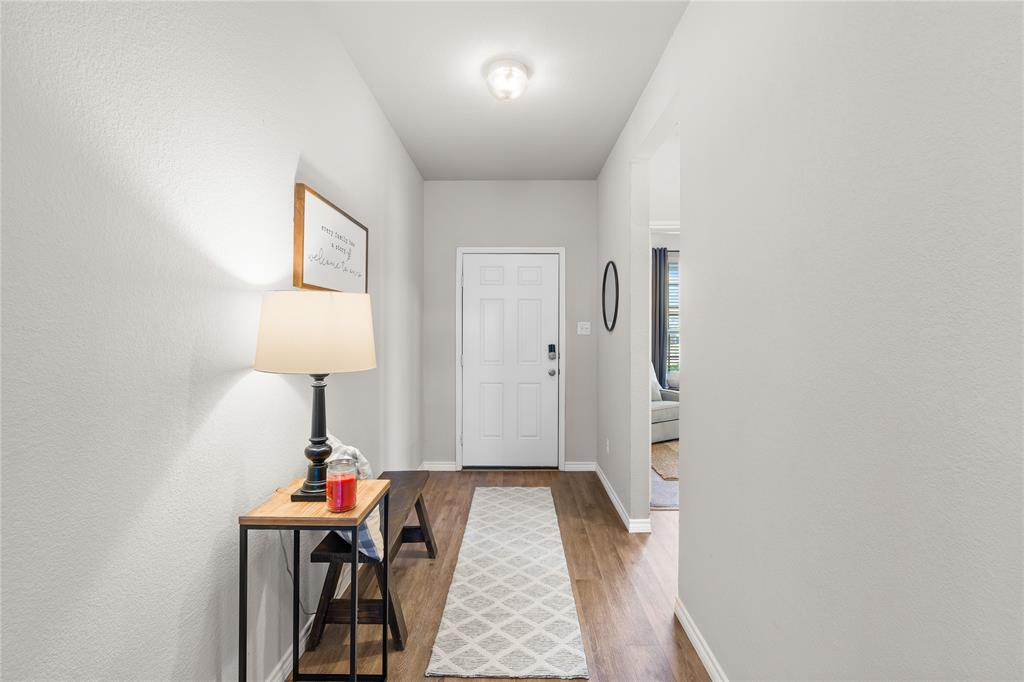 1061 Stanridge Lane Van Alstyne, TX 75495 - Photo 29 of 37 a view of a room that has a bed and a table in it