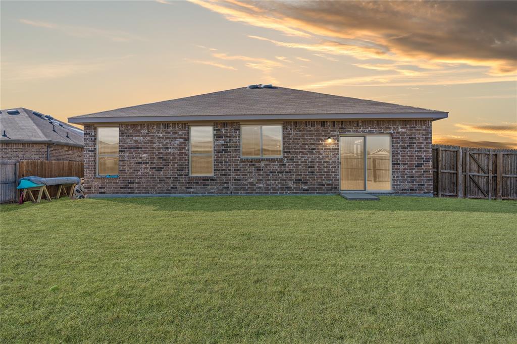 1061 Stanridge Lane Van Alstyne, TX 75495 - Photo 33 of 37 a front view of a house with garden