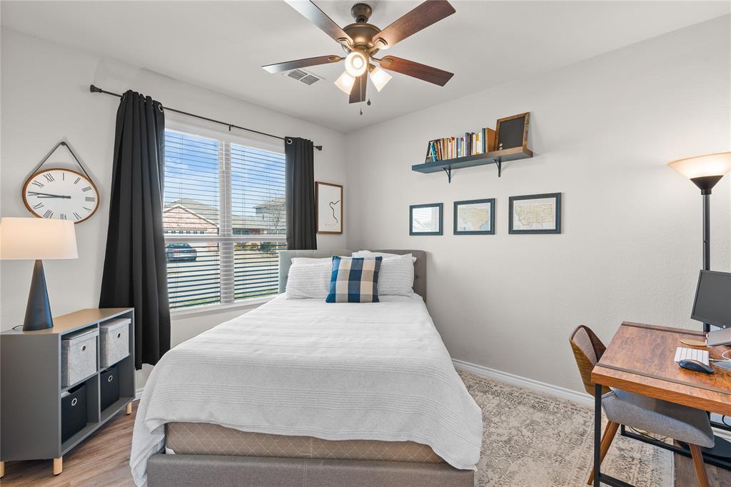 1061 Stanridge Lane Van Alstyne, TX 75495 - Photo 6 of 37 a bedroom with a bed desk and a window
