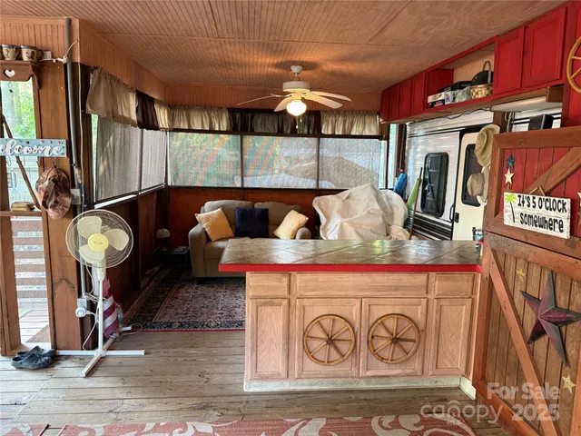 a dining room with furniture a chandelier and wooden floor