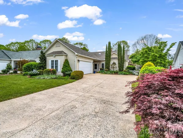a view of house with outdoor space and garden