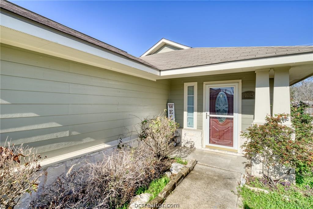 1015 Fallbrook Loop College Station, TX 77845 - Photo 2 of 15 View of exterior entry featuring a shingled roof