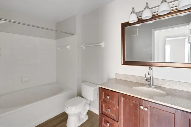 an empty room with a ceiling fan and carpet