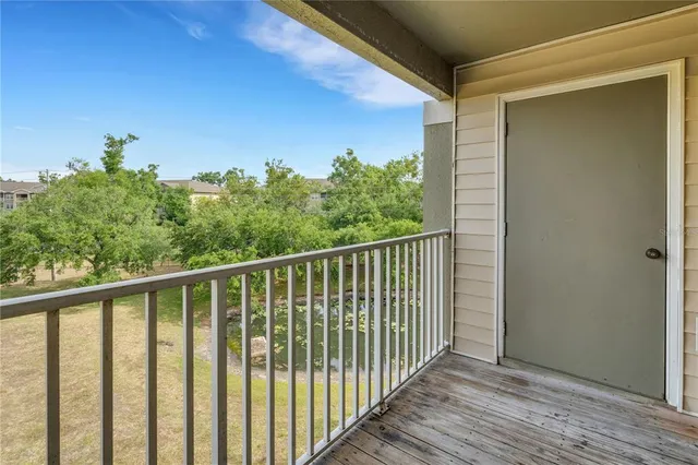 an empty room with a fan and a ceiling fan