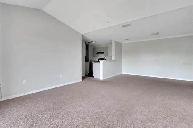 a view of a kitchen with a sink and a refrigerator