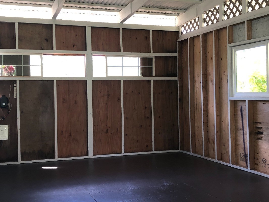 16-1568 38th Avenue Keaau, HI 96749 - Photo 19 of 30 a view of an empty room with wooden floor and windows