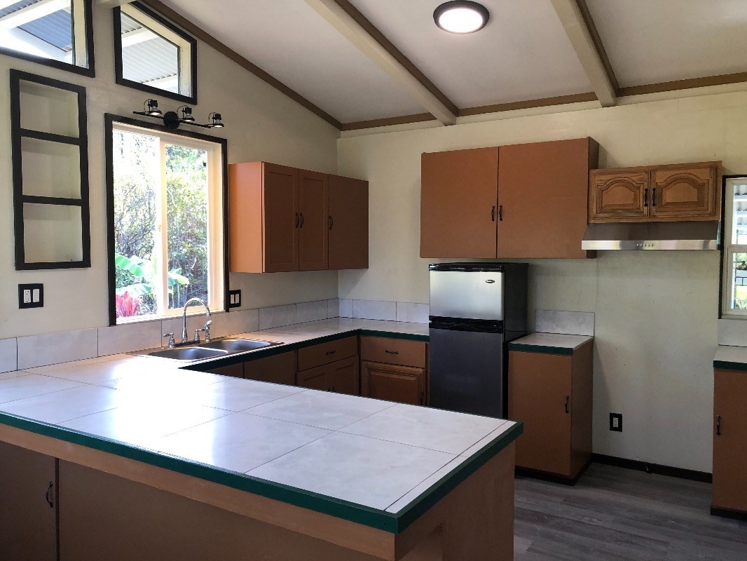 16-1568 38th Avenue Keaau, HI 96749 - Photo 2 of 30 a kitchen with a stove a sink and a refrigerator