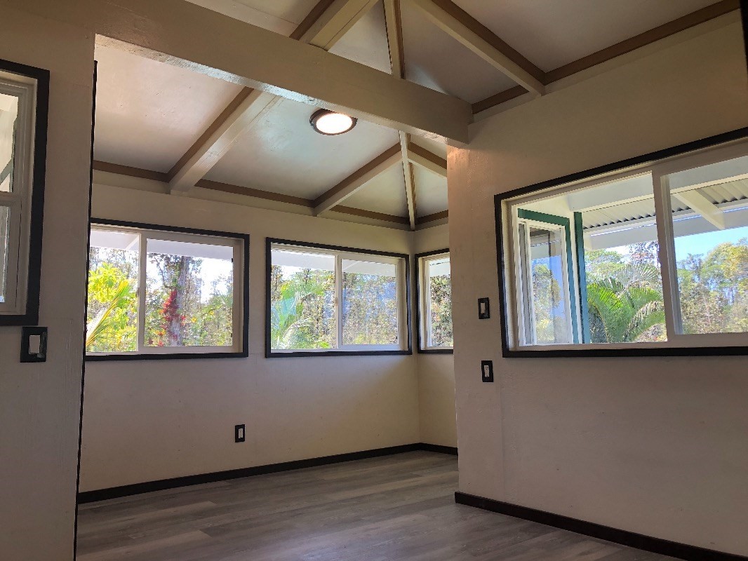 16-1568 38th Avenue Keaau, HI 96749 - Photo 8 of 30 a view of an empty room with wooden floor and a window