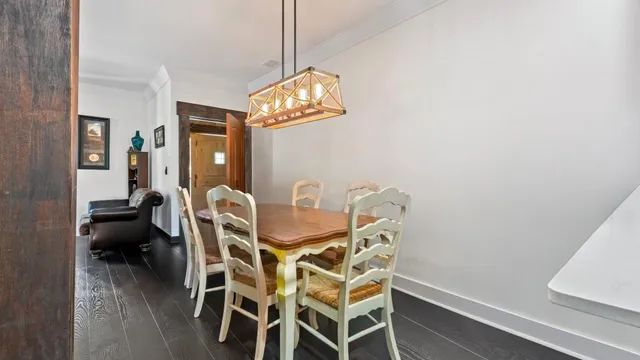 a view of a dining room with furniture and chandelier