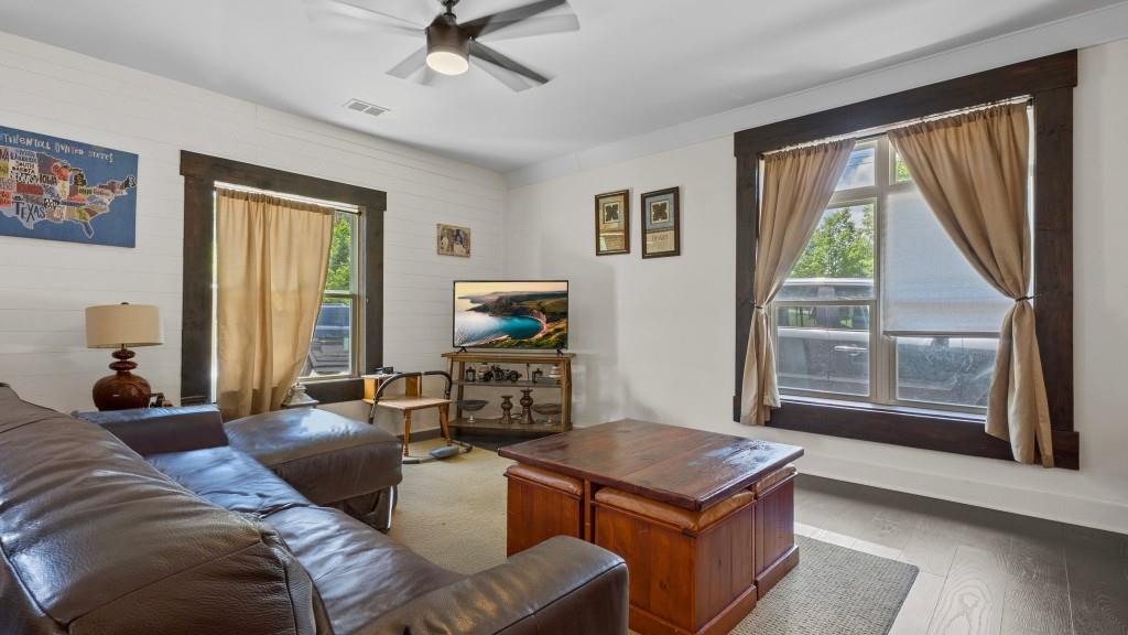 610 Madola Road, Unit 1 Epworth, GA 30541 - Photo 5 of 14 a living room with furniture a flat screen tv and a large window