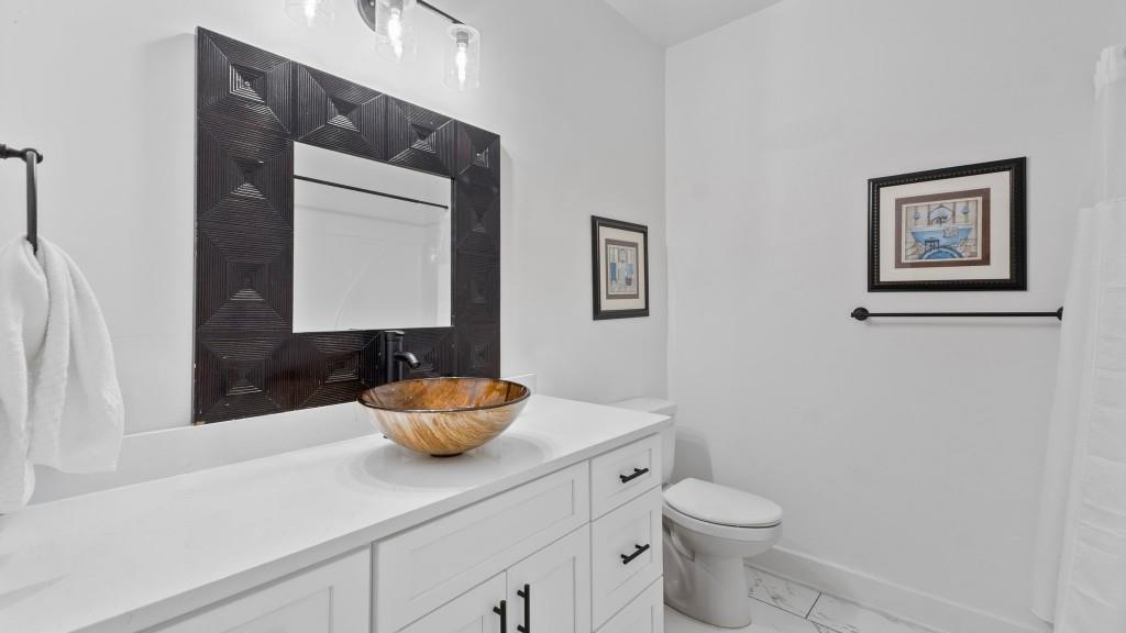610 Madola Road, Unit 1 Epworth, GA 30541 - Photo 8 of 14 a bathroom with a toilet sink and mirror