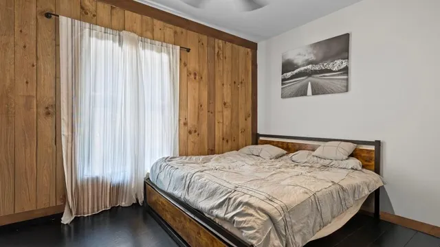 a bedroom with a bed and a window