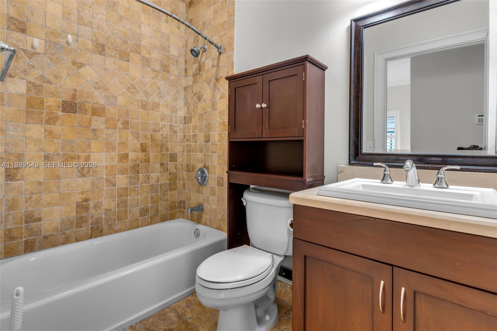 7048 Southwest 83rd Court Miami, FL 33143 - Photo 11 of 38 a bathroom with a sink toilet and shower