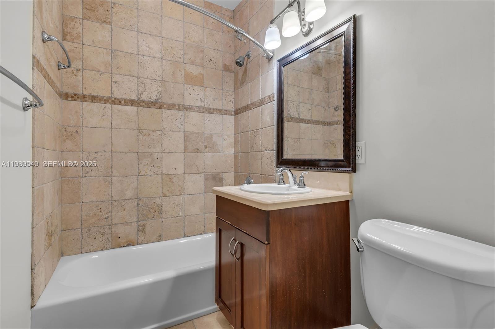 7048 Southwest 83rd Court Miami, FL 33143 - Photo 12 of 38 a bathroom with a sink a toilet and bathtub