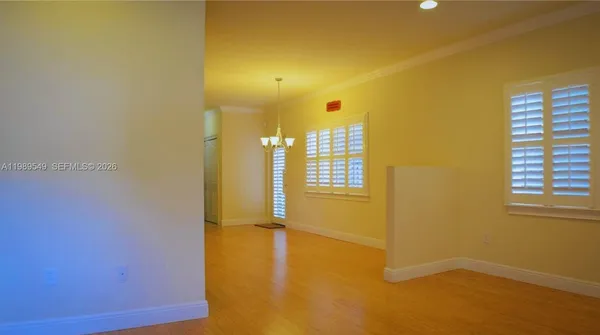 a view of a room with wooden floor and windows