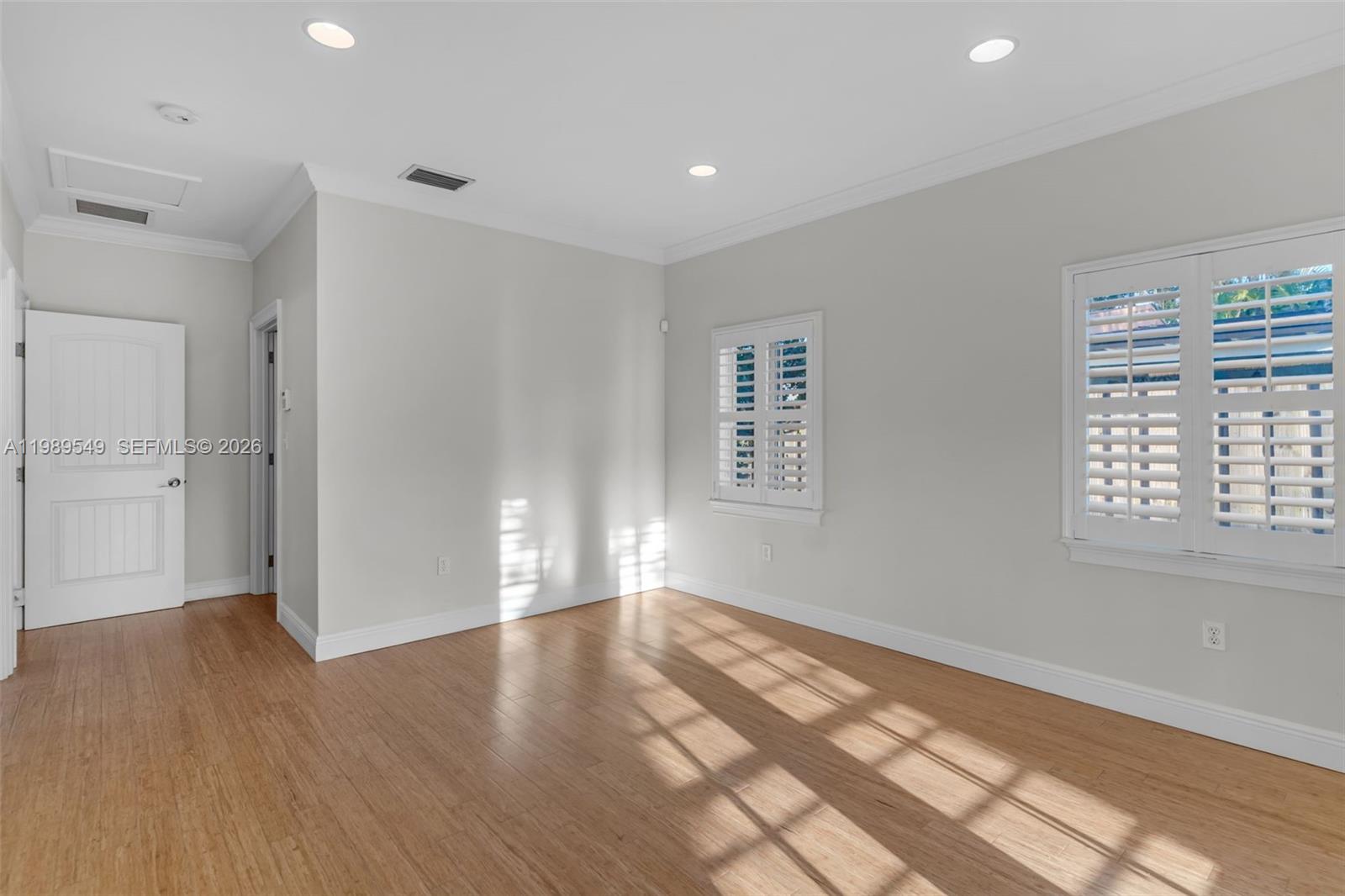 7048 Southwest 83rd Court Miami, FL 33143 - Photo 19 of 38 wooden floor in an empty room with a window