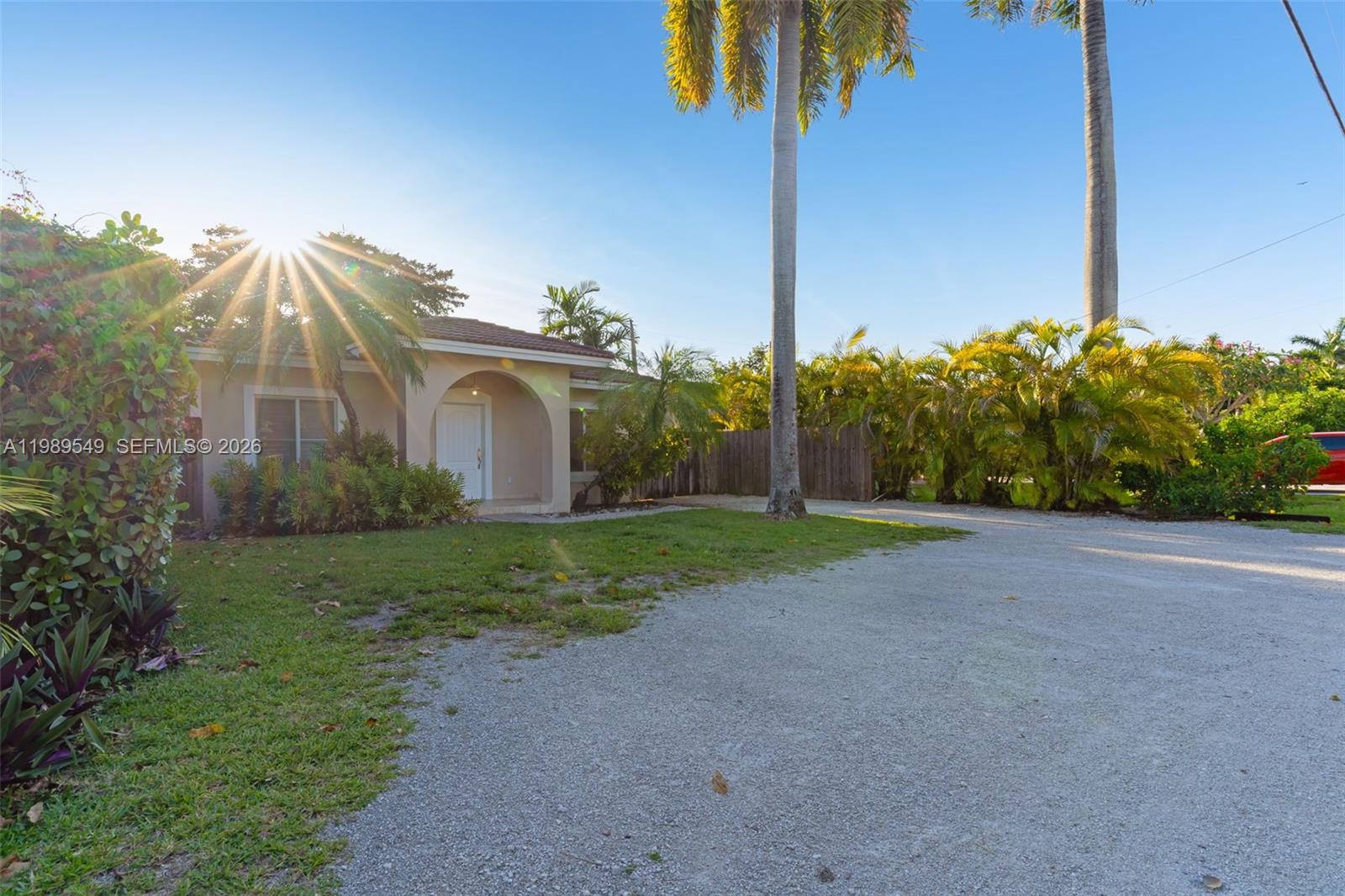 7048 Southwest 83rd Court Miami, FL 33143 - Photo 2 of 38 a view of a house with a yard and potted plants