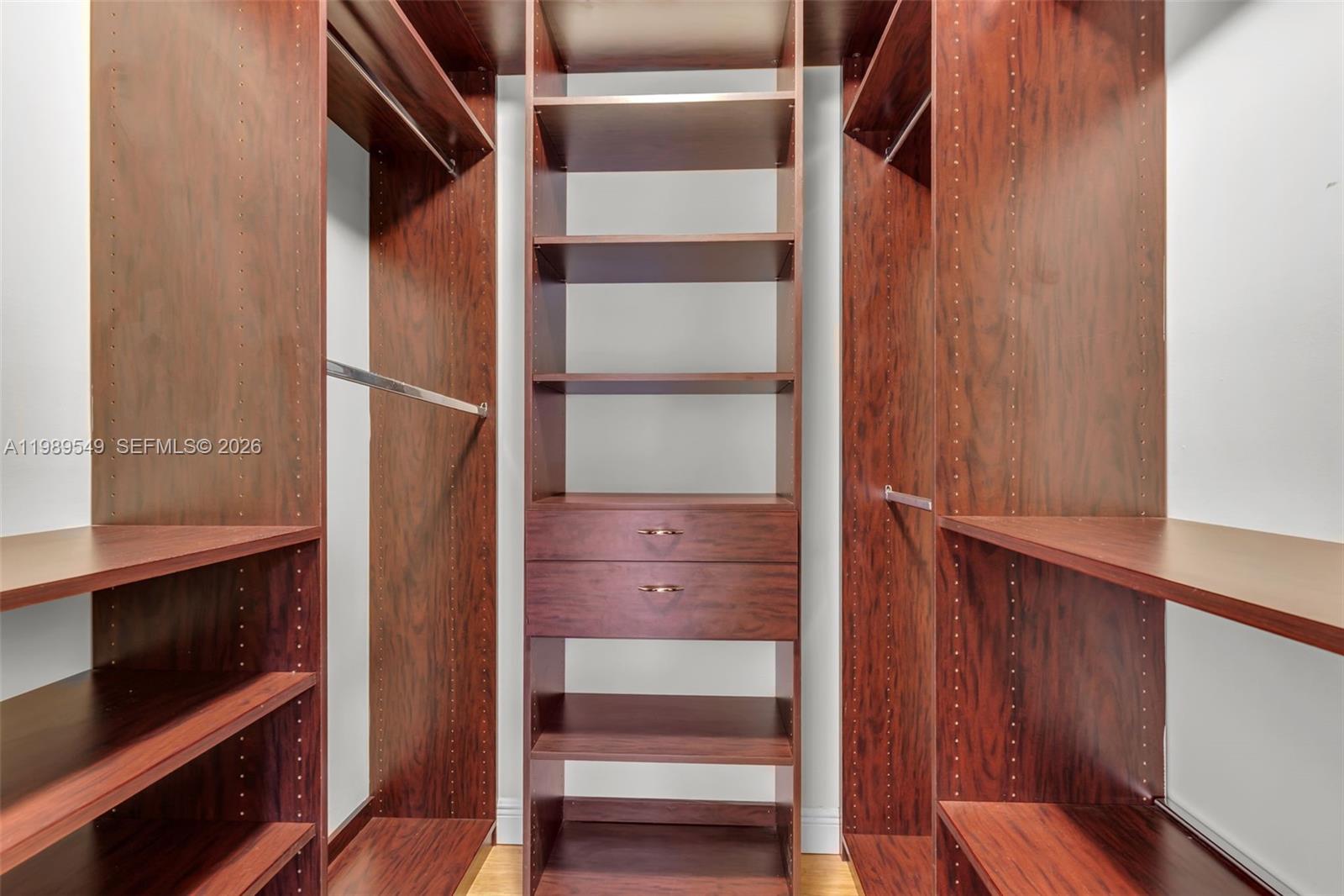 7048 Southwest 83rd Court Miami, FL 33143 - Photo 21 of 38 a view of walk in closet with empty racks
