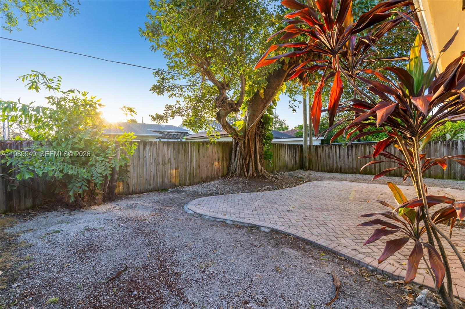 7048 Southwest 83rd Court Miami, FL 33143 - Photo 25 of 38 a view of a house with a tree and a yard
