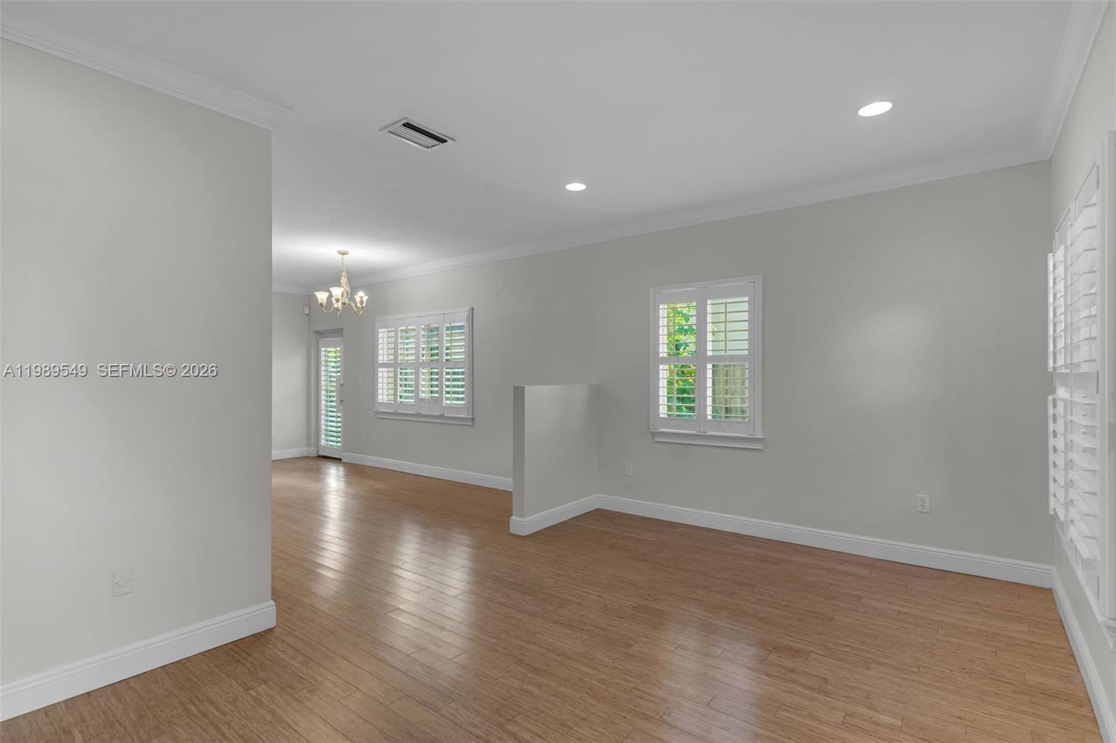 7048 Southwest 83rd Court Miami, FL 33143 - Photo 4 of 38 a view of an empty room with wooden floor and a window