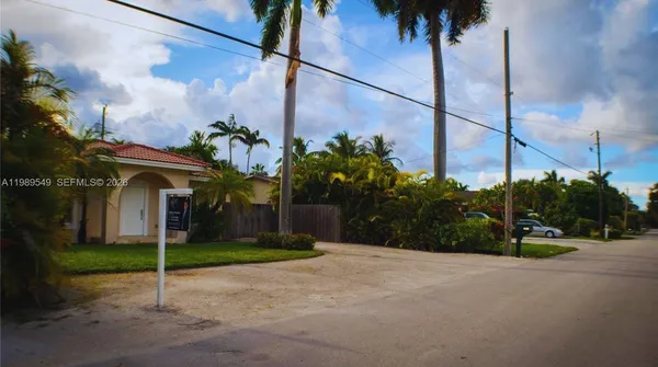 a view of a street with a building in the background