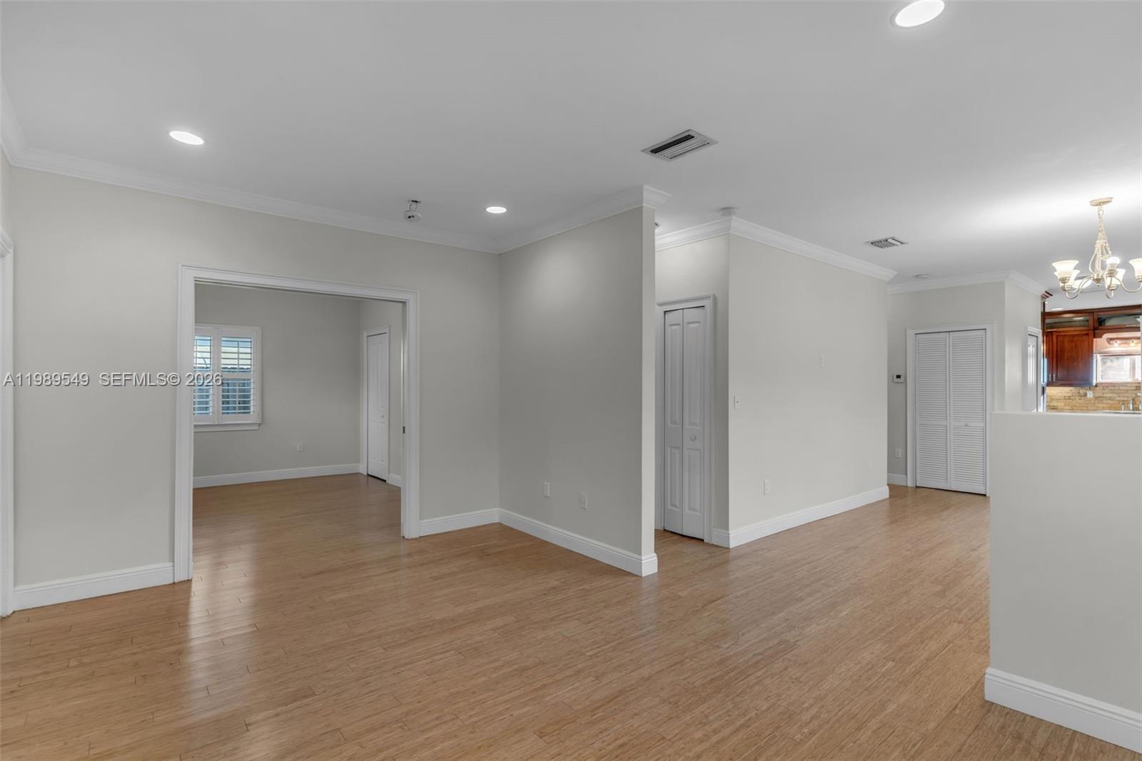 7048 Southwest 83rd Court Miami, FL 33143 - Photo 5 of 38 an empty room with wooden floor and windows