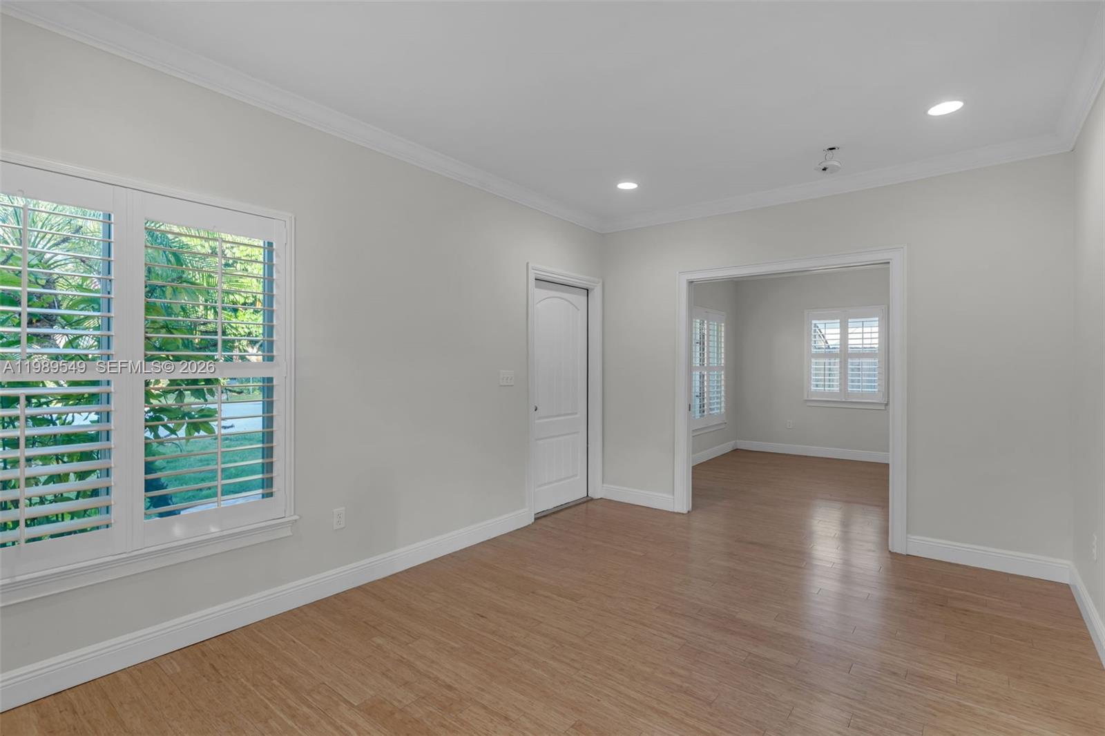 7048 Southwest 83rd Court Miami, FL 33143 - Photo 6 of 38 a view of an empty room with wooden floor and a window