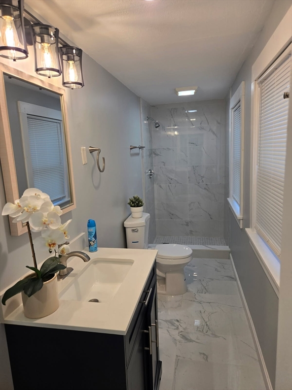 135 Guild Road Brockton, MA 02302 - Photo 1 of 12 a bathroom with a sink a toilet and shower