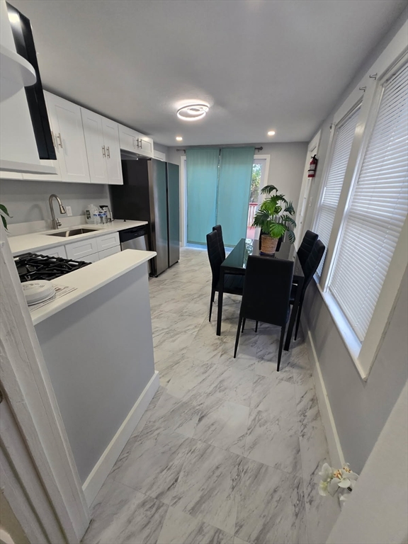 135 Guild Road Brockton, MA 02302 - Photo 4 of 12 a living room with furniture a dining table and a potted plant