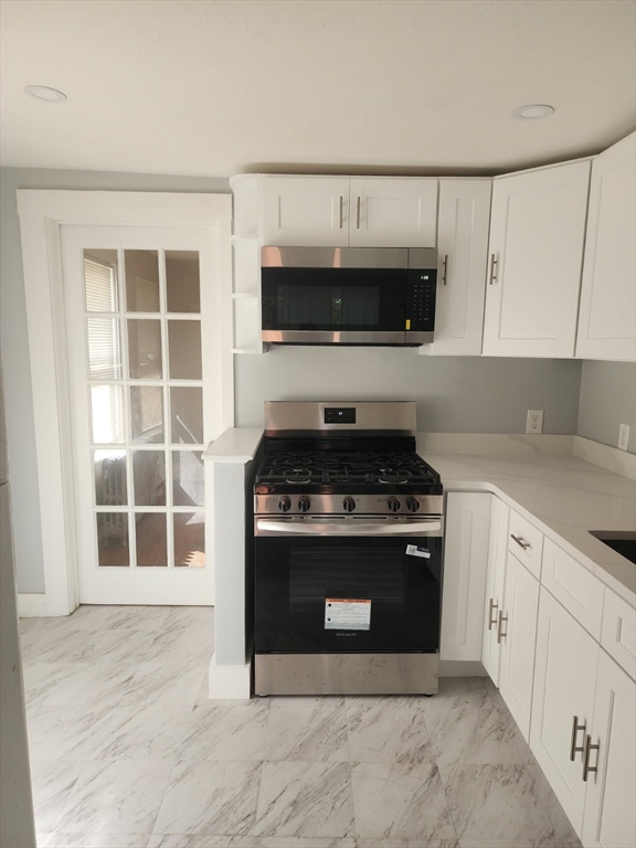135 Guild Road Brockton, MA 02302 - Photo 6 of 12 a kitchen with stainless steel appliances granite countertop a stove and a sink