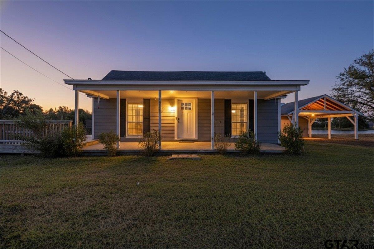 a front view of a house with a garden