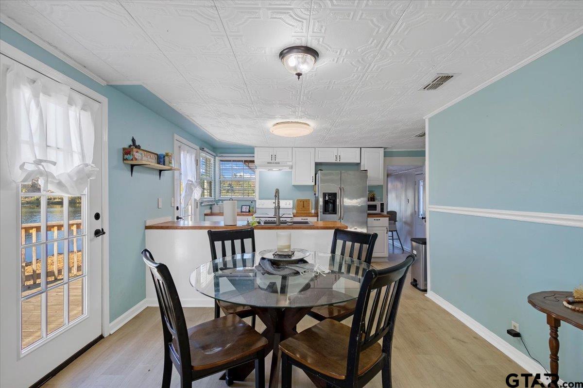 10286 US Highway 69 North Tyler, TX 75706 - Photo 19 of 31 a view of a dining room with furniture and wooden floor