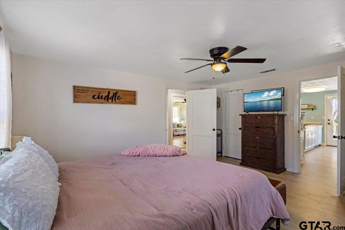 10286 US Highway 69 North Tyler, TX 75706 - Photo 24 of 31 a bedroom with a bed and a chandelier